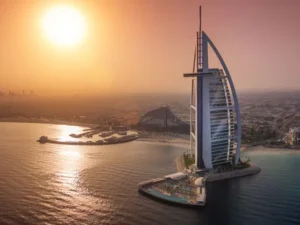 Aerial view of Burj Al Arab at sunset representing Dubai luxury property investment for London buyers